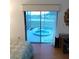 Relaxing bedroom with sliding glass doors leading to an outdoor pool area at 12966 Broakfield Cir, Orlando, FL 32837