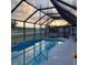 Enclosed pool area reflecting a scenic sky, complemented by outdoor seating for relaxation at 12966 Broakfield Cir, Orlando, FL 32837