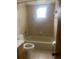 Clean bathroom with tiled walls, a tub and shower combo, and updated fixtures at 1304 Mill Creek Pl, Kissimmee, FL 34744