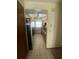 Galley kitchen featuring tile floor, oak cabinets, stainless steel appliances, and a ceiling fan at 1304 Mill Creek Pl, Kissimmee, FL 34744