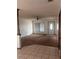 Living room boasts ample light, carpet flooring and view of front door and tile entryway at 1304 Mill Creek Pl, Kissimmee, FL 34744