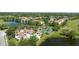 Beautiful aerial view of a home community featuring lush landscaping, pools, and a golf course at 14049 Fairway Island Dr # 122, Orlando, FL 32837
