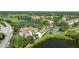 Aerial view showcasing the condo community amenities and the surrounding golf course and pond at 14049 Fairway Island Dr # 122, Orlando, FL 32837