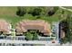 An aerial view showcasing the tile roofs and landscaping of the multi-story condo building at 14049 Fairway Island Dr # 122, Orlando, FL 32837