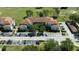 An aerial view of the condo buildings, parking, landscaping, and proximity to grassy lawns and lake at 14049 Fairway Island Dr # 122, Orlando, FL 32837