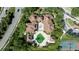 Aerial view showcasing tile roofs, a pool, a fountain, and manicured landscaping at 14049 Fairway Island Dr # 122, Orlando, FL 32837