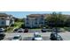 Beautiful two-story condo building featuring ample parking, well-maintained landscaping, and neutral stucco siding at 14049 Fairway Island Dr # 122, Orlando, FL 32837