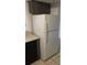 Appliance view of a white refrigerator next to black dishwasher and wood cabinets at 14049 Fairway Island Dr # 122, Orlando, FL 32837
