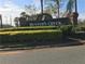 A view of the Hunter's Creek Community entrance sign with a manicured yard at 14049 Fairway Island Dr # 127, Orlando, FL 32837