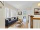 Inviting staged loft area with plantation shutters, a comfortable couch, and a view into an adjacent bedroom at 1589 Resolute St, Celebration, FL 34747