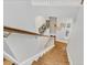 Downward view of wooden staircase with white trim, accentuated with wall art and coat rack with storage at 1589 Resolute St, Celebration, FL 34747