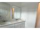 Double sink vanity in the bathroom features modern faucets and white cabinets at 2414 Skyline Loop, Kissimmee, FL 34758