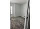 Bright bedroom featuring neutral walls, plush carpeting, and natural light from the window at 2414 Skyline Loop, Kissimmee, FL 34758