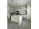 Bright kitchen with white cabinets, quartz countertops, stainless steel appliances, and a center island at 2414 Skyline Loop, Kissimmee, FL 34758