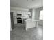 Bright kitchen featuring white cabinets, quartz countertops, stainless steel appliances, and a center island at 2414 Skyline Loop, Kissimmee, FL 34758