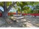 Backyard features a cozy outdoor seating area with mature trees, complemented by a rustic fire pit for relaxation at 2429 Oak Run Blvd, Kissimmee, FL 34744