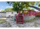 Backyard featuring a wooden deck, a white shed, and space for relaxing at 2429 Oak Run Blvd, Kissimmee, FL 34744