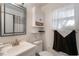 Bright bathroom featuring a vanity, toilet, and mirrored cabinet at 2429 Oak Run Blvd, Kissimmee, FL 34744