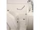 Close-up of accessible walk-in bathtub with safety grab bar and modern chrome faucet at 2429 Oak Run Blvd, Kissimmee, FL 34744