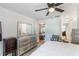 Bright bedroom with white walls, a ceiling fan, and access to an adjacent dining area at 2429 Oak Run Blvd, Kissimmee, FL 34744