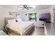 Cozy bedroom with light flooring, decorative wall art, and large window at 2429 Oak Run Blvd, Kissimmee, FL 34744