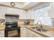 Functional kitchen featuring essential appliances and bright natural light from the window at 2429 Oak Run Blvd, Kissimmee, FL 34744