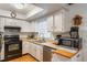 Bright kitchen with white cabinets, essential appliances, and ample counter space at 2429 Oak Run Blvd, Kissimmee, FL 34744