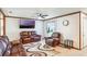 Comfortable living room with leather seating, a ceiling fan, and a wall-mounted TV at 2429 Oak Run Blvd, Kissimmee, FL 34744