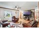Spacious living room with a ceiling fan, large windows, and comfortable seating arrangement at 2429 Oak Run Blvd, Kissimmee, FL 34744