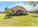 Grassy backyard with patio area featuring a gazebo and a grill at 2706 Sebastian Ct, Kissimmee, FL 34743