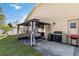Relaxing backyard patio with gazebo featuring lounge seating, adjacent to a grill area at 2706 Sebastian Ct, Kissimmee, FL 34743