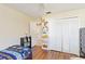Bedroom with wood floors, closet, and doorway to an ensuite at 2706 Sebastian Ct, Kissimmee, FL 34743