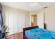 A clean and bright bedroom with a closet, ceiling fan, and view into an ensuite bathroom at 2706 Sebastian Ct, Kissimmee, FL 34743