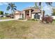 Charming single-story house showcases a lush green lawn, a spacious driveway, and mature palm trees at 2706 Sebastian Ct, Kissimmee, FL 34743