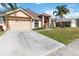 Attractive single-Gathering home with a well-kept lawn, a concrete driveway, and a convenient two-car garage at 2706 Sebastian Ct, Kissimmee, FL 34743