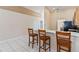 Kitchen with breakfast bar and high top chairs, tile flooring, and an open floorplan at 2706 Sebastian Ct, Kissimmee, FL 34743
