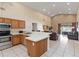Open kitchen featuring tile floors, an island with seating, modern appliances, and a seamless transition to the living room at 2706 Sebastian Ct, Kissimmee, FL 34743