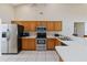 Well-lit kitchen features stainless steel appliances, lots of wooden cabinet space, and a breakfast bar at 2706 Sebastian Ct, Kissimmee, FL 34743