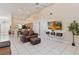 Inviting living room with tile flooring, a ceiling fan, high ceilings, and an open layout with kitchen views at 2706 Sebastian Ct, Kissimmee, FL 34743