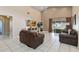 Spacious living room featuring tile flooring, a ceiling fan, a sliding door, and comfortable seating at 2706 Sebastian Ct, Kissimmee, FL 34743