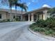 Well-maintained clubhouse with a covered entryway and inviting landscaping at 2809 Wingfoot Ct, Winter Haven, FL 33884