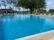 Large community pool featuring plenty of deck seating and shaded areas at 2809 Wingfoot Ct, Winter Haven, FL 33884