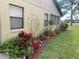 Well-manicured garden and flowers along the side of the home's exterior at 2809 Wingfoot Ct, Winter Haven, FL 33884