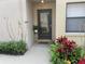 Charming front entrance with a decorative door and colorful landscaping at 2809 Wingfoot Ct, Winter Haven, FL 33884