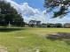 Expansive green space with mature trees and manicured lawn, offering scenic views and recreational opportunities at 2809 Wingfoot Ct, Winter Haven, FL 33884