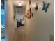 Hallway with decorative butterfly art leads to living areas, showcasing the home's thoughtful interior design at 2809 Wingfoot Ct, Winter Haven, FL 33884