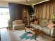 Cozy living room with large windows, comfortable seating, and a decorative rug, creating a welcoming atmosphere at 2809 Wingfoot Ct, Winter Haven, FL 33884