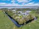 Stunning aerial view of waterfront homes with access to a large lake and surrounded by lush greenery at 3409 Lake Diane Rd, Tavares, FL 32778