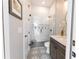 Elegant bathroom features a tiled shower with glass door, decorative floor tiles, and a vanity with modern fixtures at 3409 Lake Diane Rd, Tavares, FL 32778