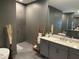 Bathroom with gray cabinets, double vanity, and a walk-in shower with gray tile at 3409 Lake Diane Rd, Tavares, FL 32778